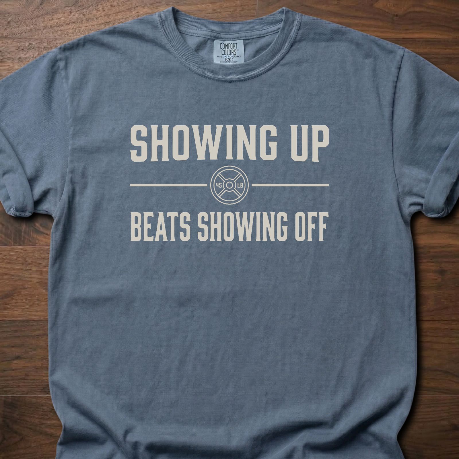 Showing Up strength training t-shirt with motivational message and weight plate design – Blue Jean