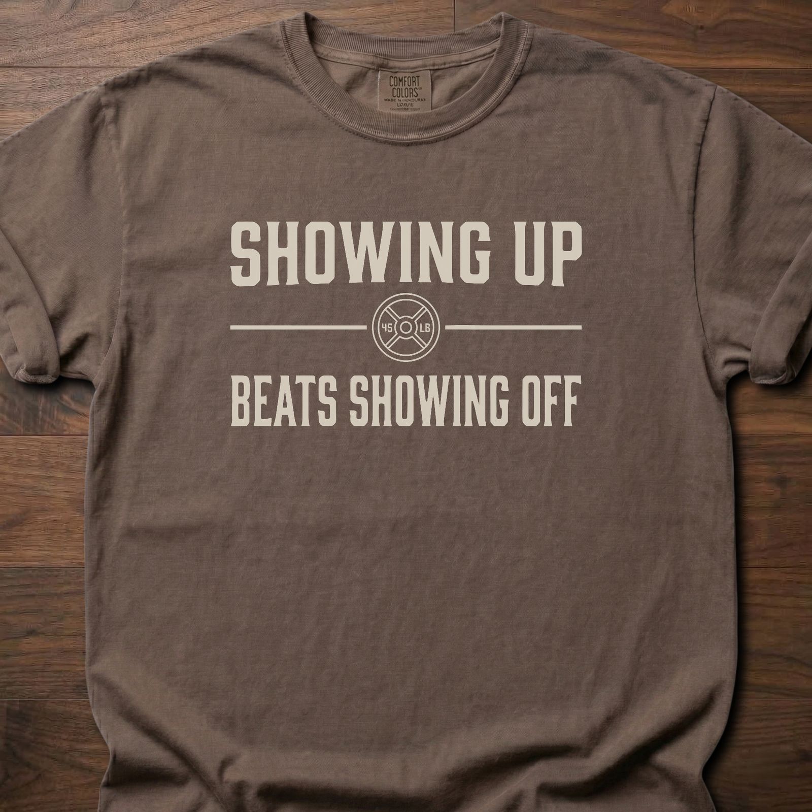 Showing Up strength training t-shirt with motivational message and weight plate design – Espresso