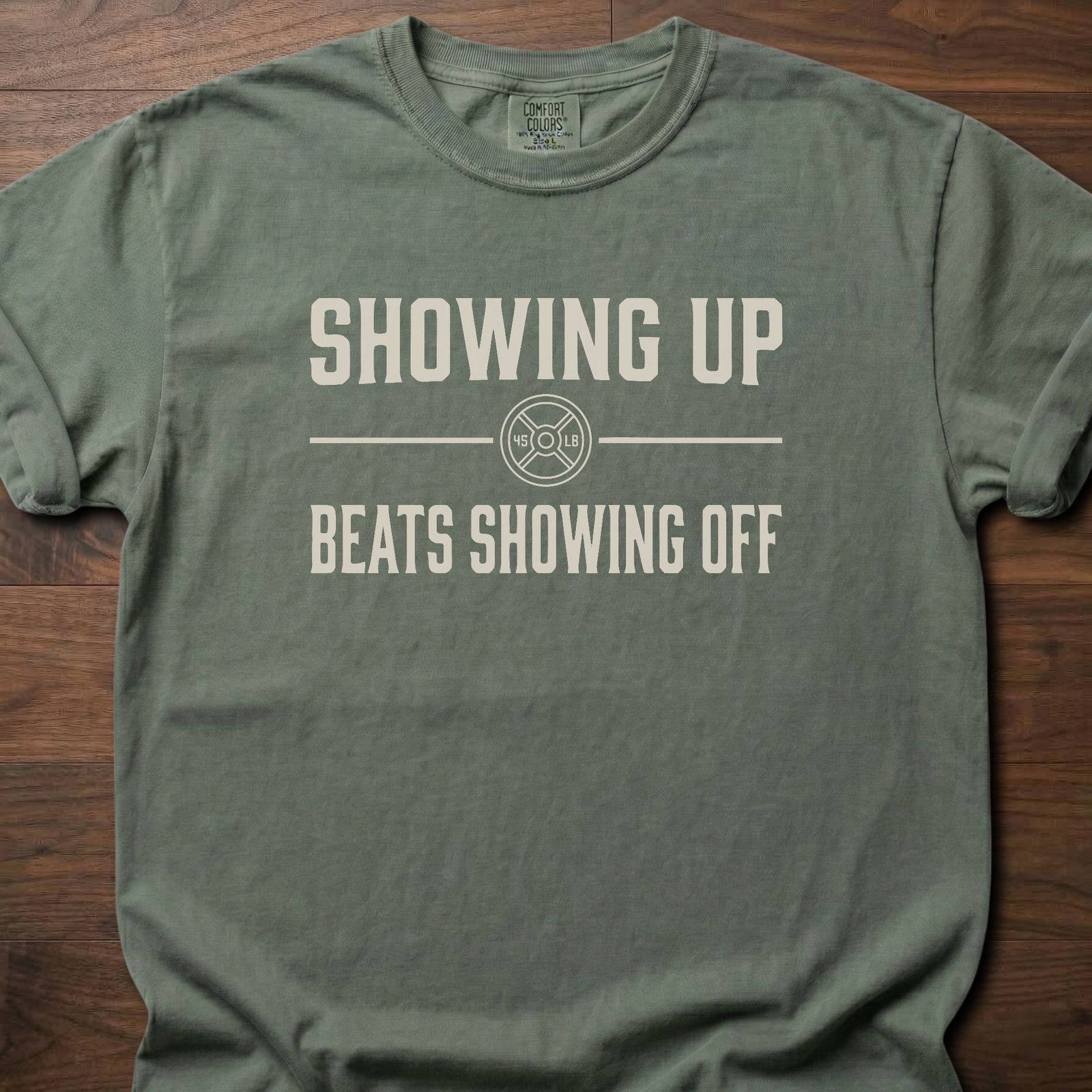 Showing Up strength training t-shirt with motivational message and weight plate design – Moss