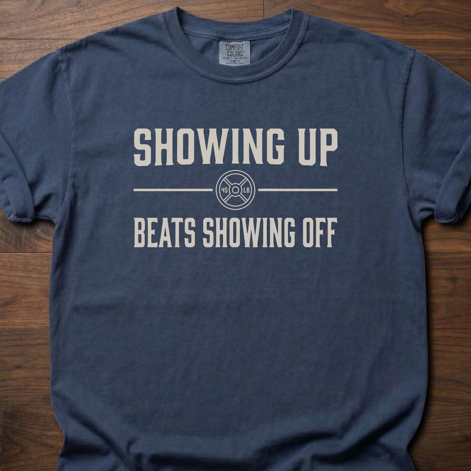 Showing Up strength training t-shirt with motivational message and weight plate design – Navy