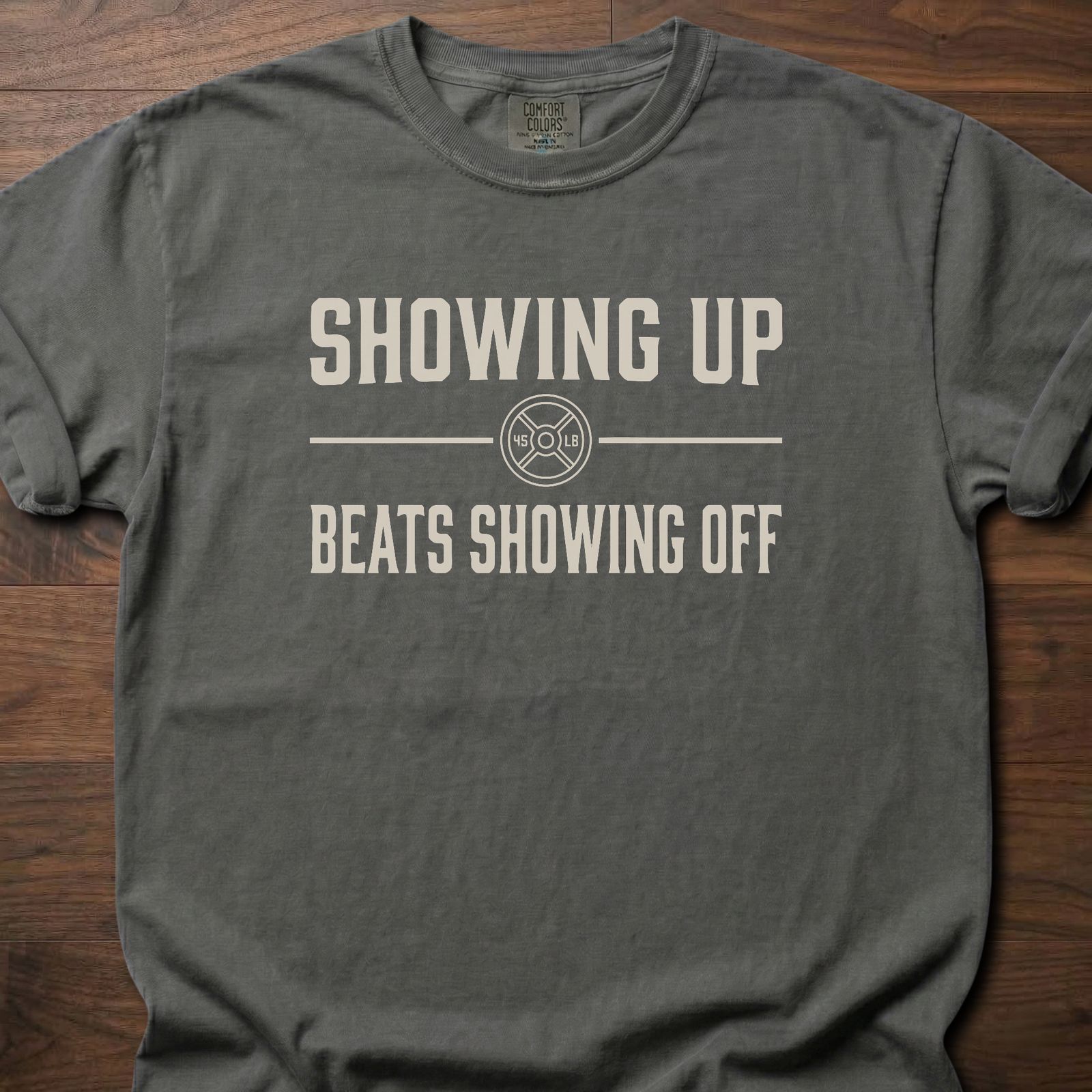 Showing Up strength training t-shirt with motivational message and weight plate design – Pepper