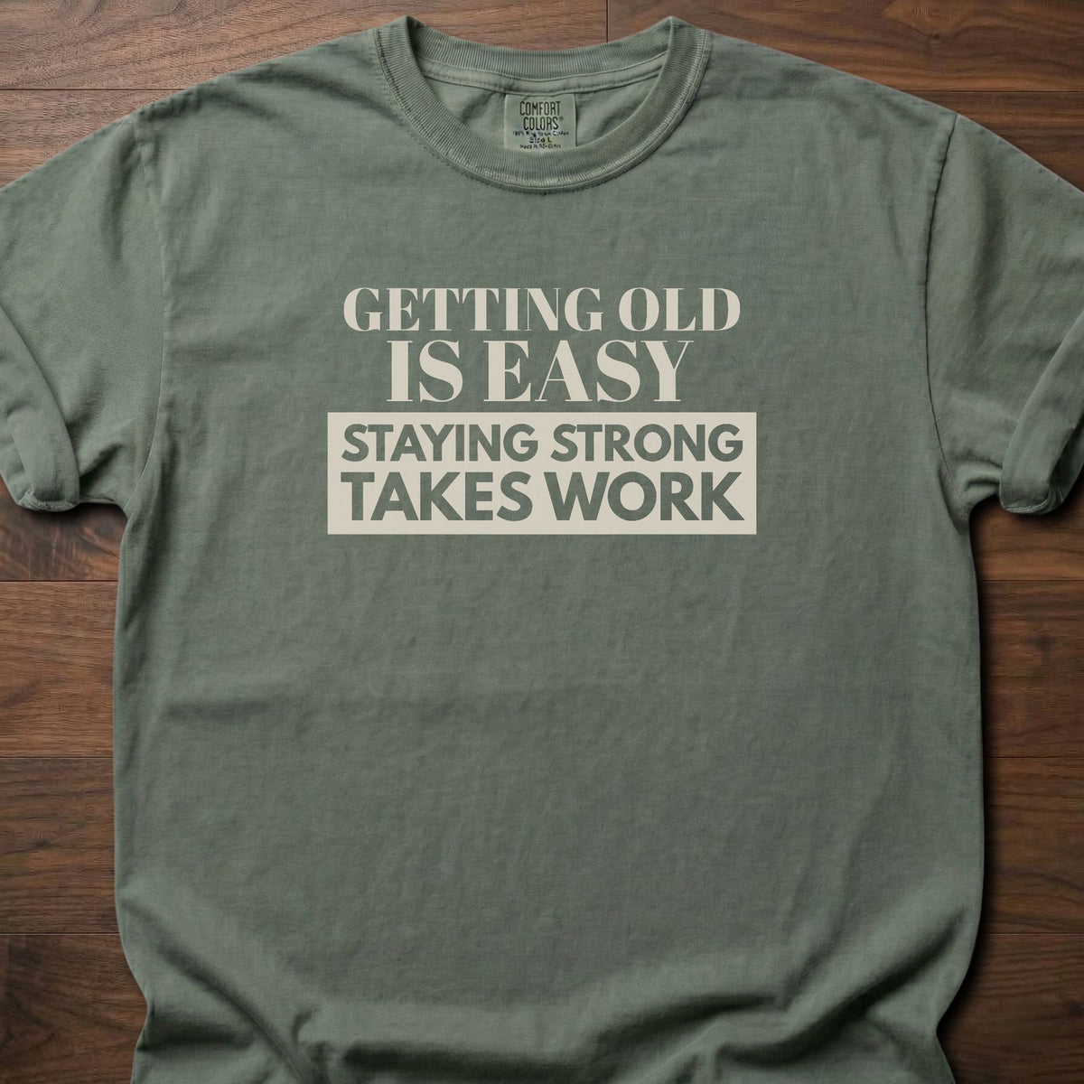 Staying Strong strength training t-shirt with bold vintage-style typographic graphic – Moss