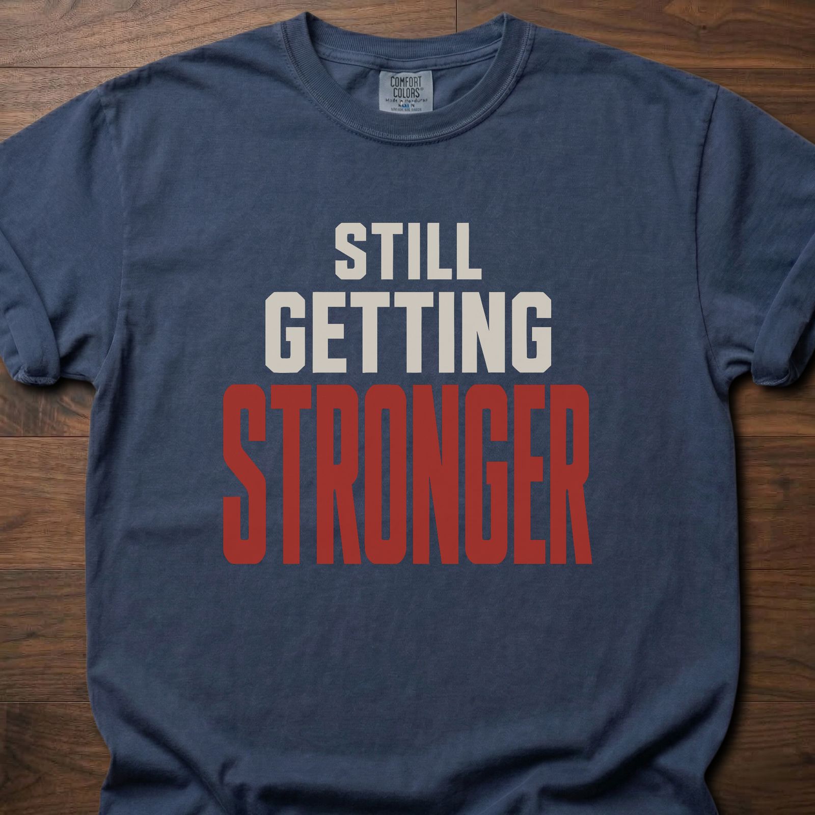Still Getting Stronger strength training t-shirt with bold stacked block lettering – Navy