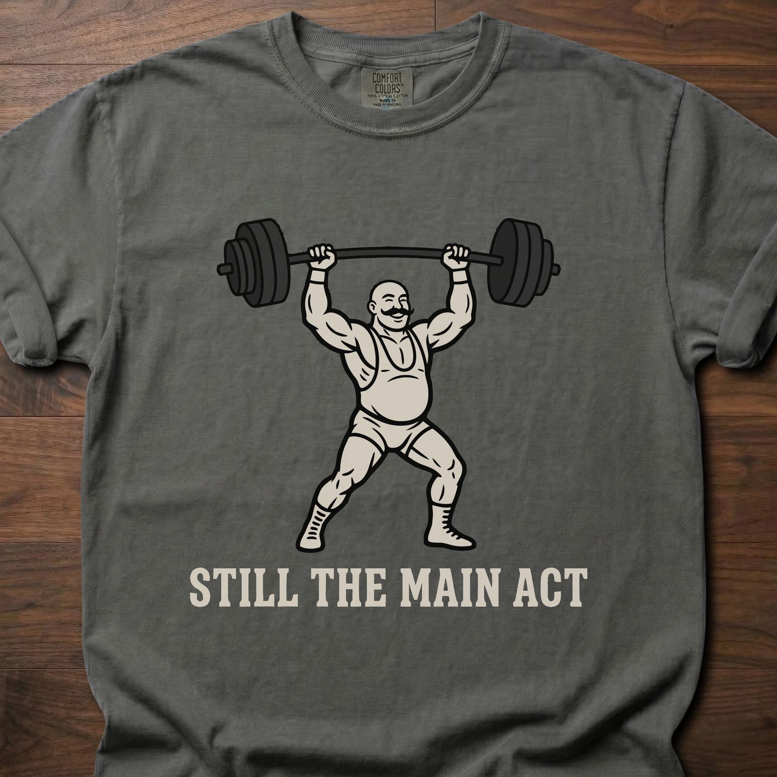 Still The Main Act fitness lifestyle t shirts featuring strongman lifting heavy barbell overhead – Pepper