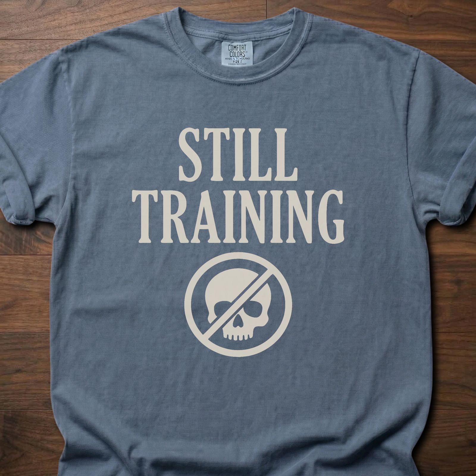 Still Training longevity fitness apparel t-shirt with crossed-out skull logo design – Blue Jean