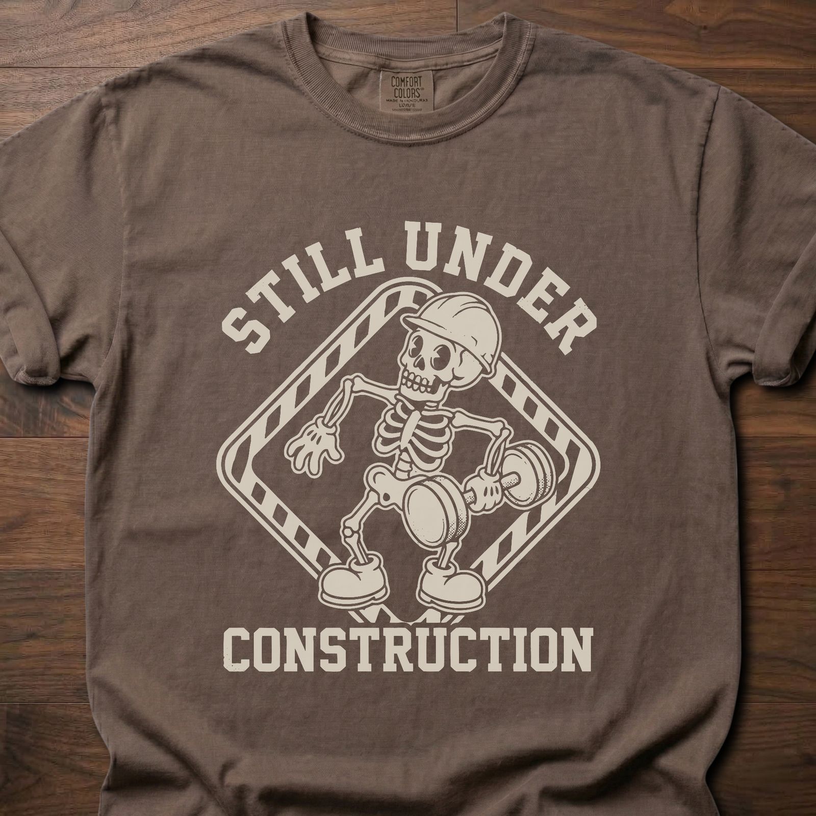 Still Under Construction strength training t shirt featuring skeleton with hard hat and caution tape design – Espresso