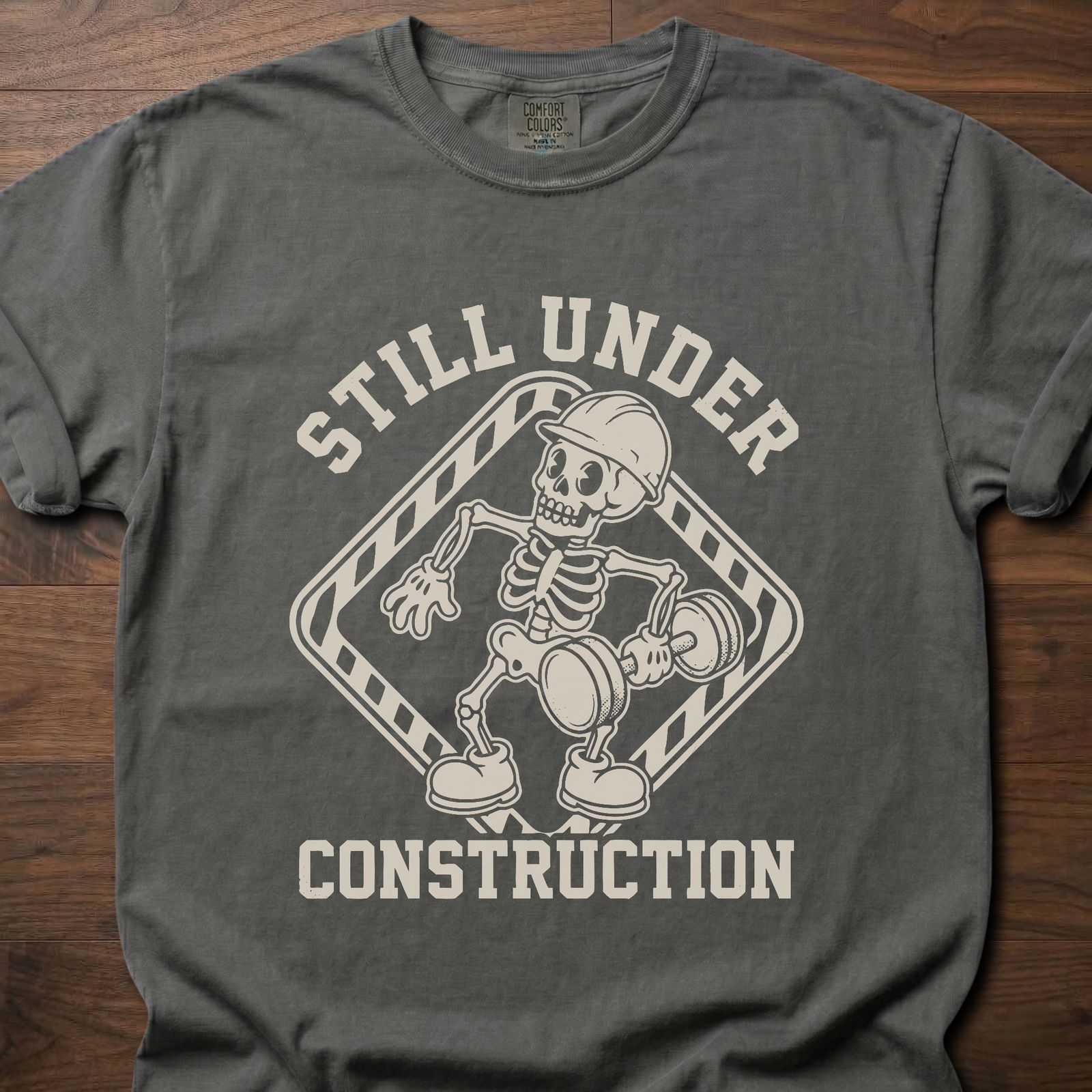 Still Under Construction strength training t shirt featuring skeleton with hard hat and caution tape design – Pepper