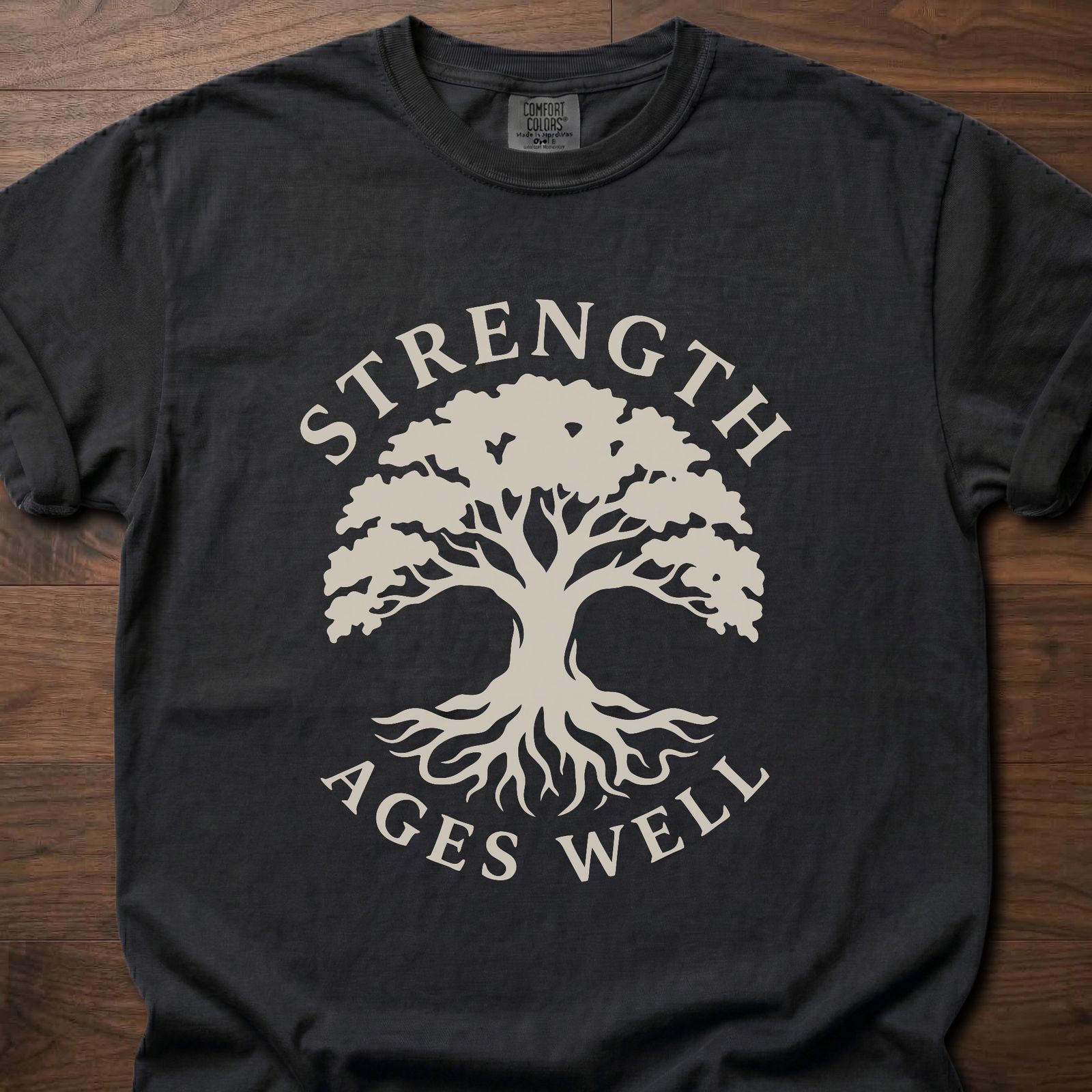 Strength Ages Well strength training t-shirt with tree of life design symbolizing deep roots and growth – Black