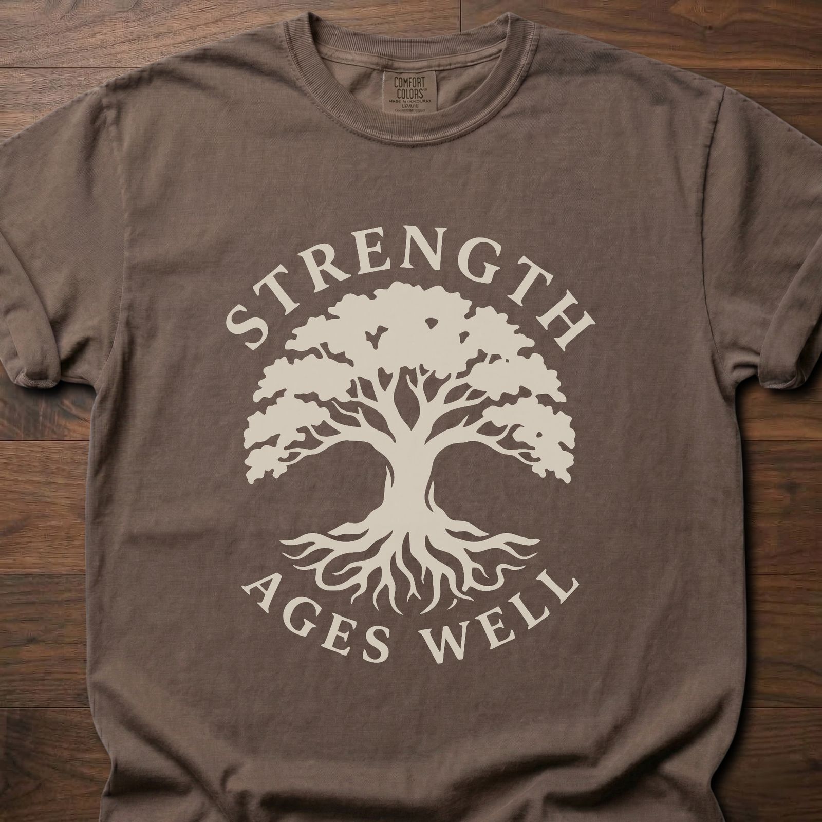 Strength Ages Well strength training t-shirt with tree of life design symbolizing deep roots and growth – Espresso