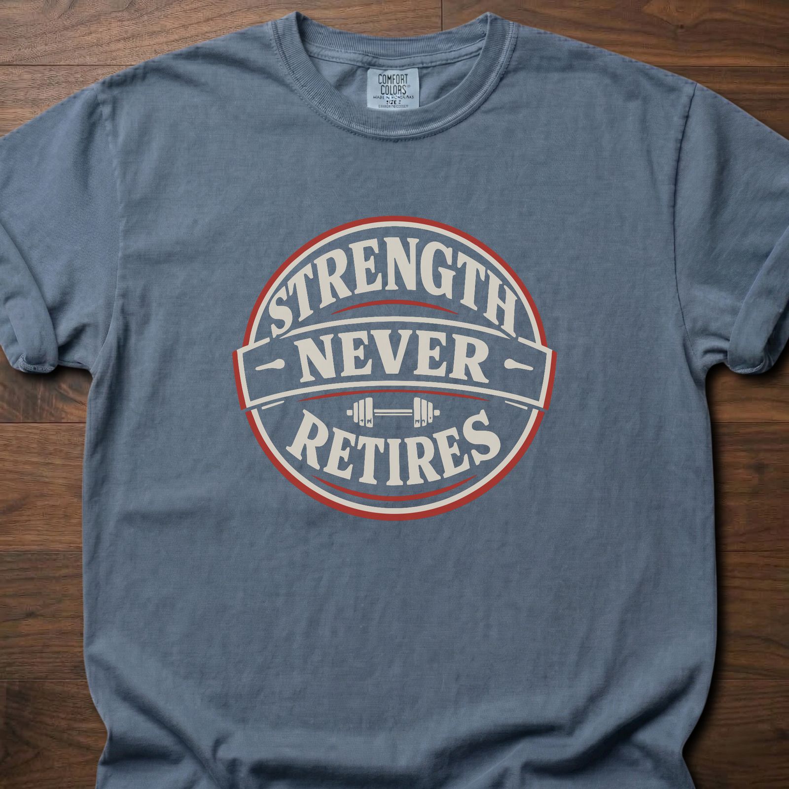 Strength Never Retires fitness lifestyle apparel shirt with circular badge and barbell design – Blue Jean