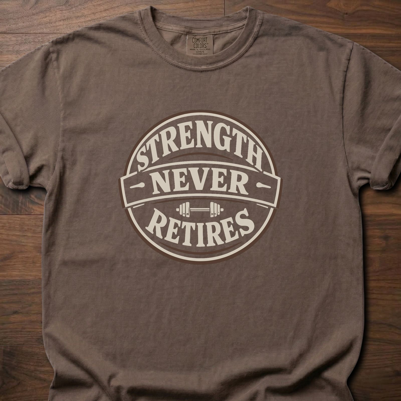 Strength Never Retires fitness lifestyle apparel shirt with circular badge and barbell design – Espresso