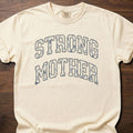 Strong Mother strength training t-shirt with bold varsity lettering design – Ivory