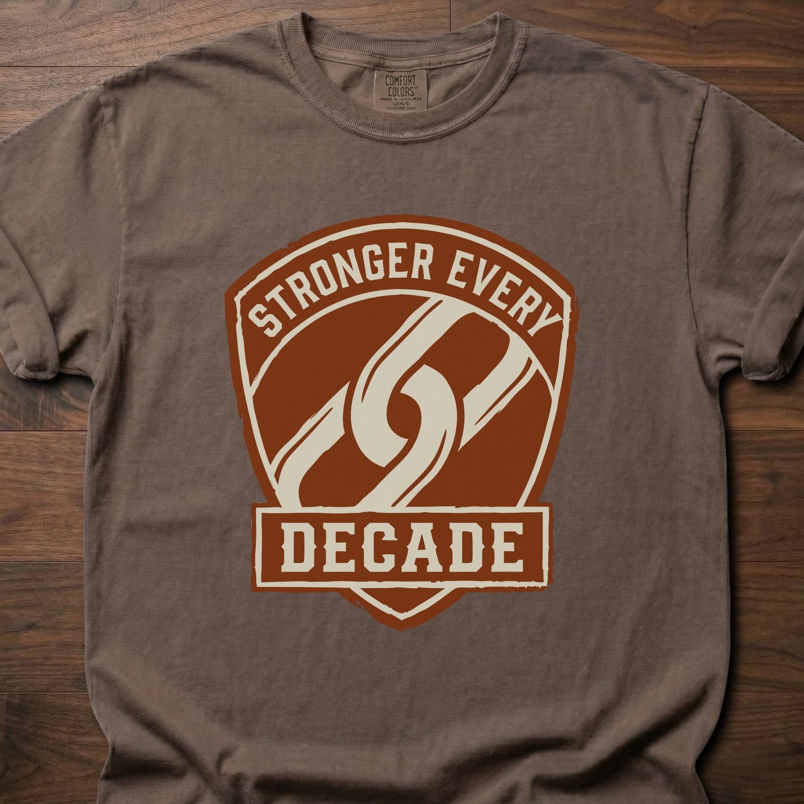 Stronger Every Decade strength training lifestyle clothing with shield emblem and diagonal stripe design – Espresso