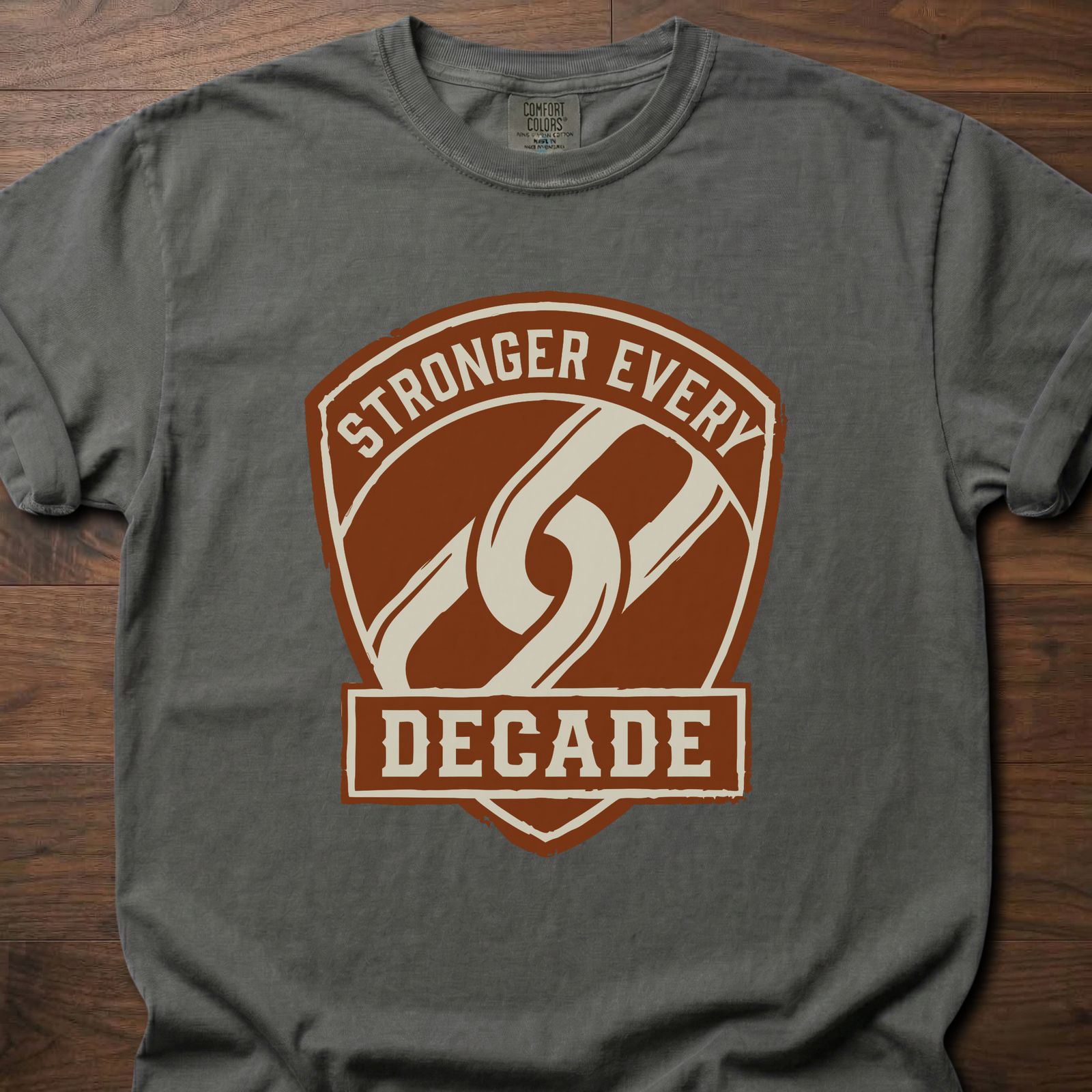 Stronger Every Decade strength training lifestyle clothing with shield emblem and diagonal stripe design – Pepper