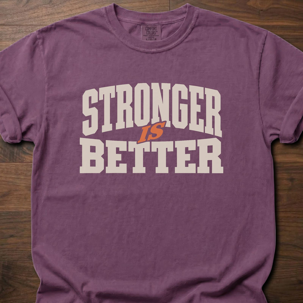 Stronger Is Better strength training t-shirt with bold collegiate block letter graphic – Berry