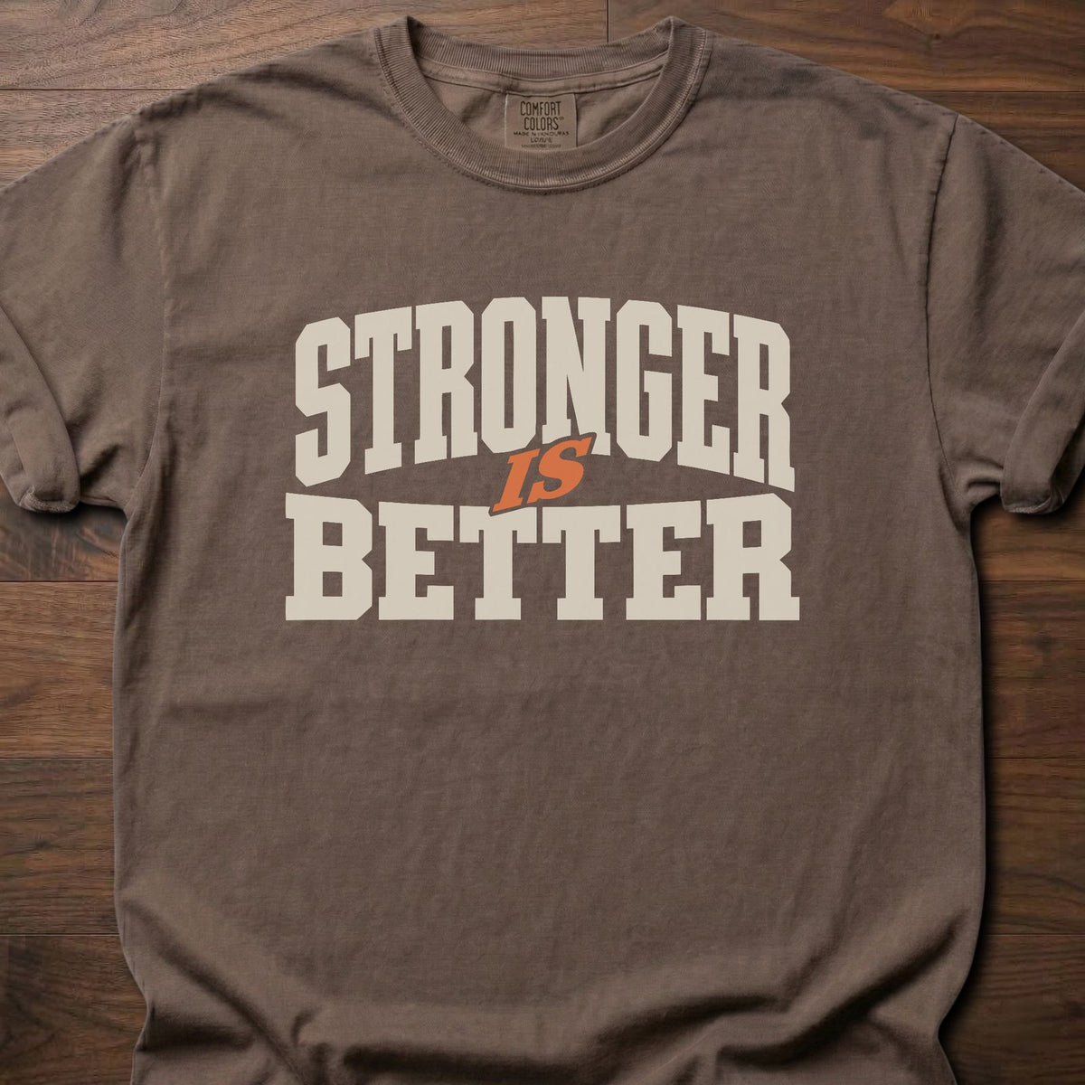 Stronger Is Better strength training t-shirt with bold collegiate block letter graphic – Espresso