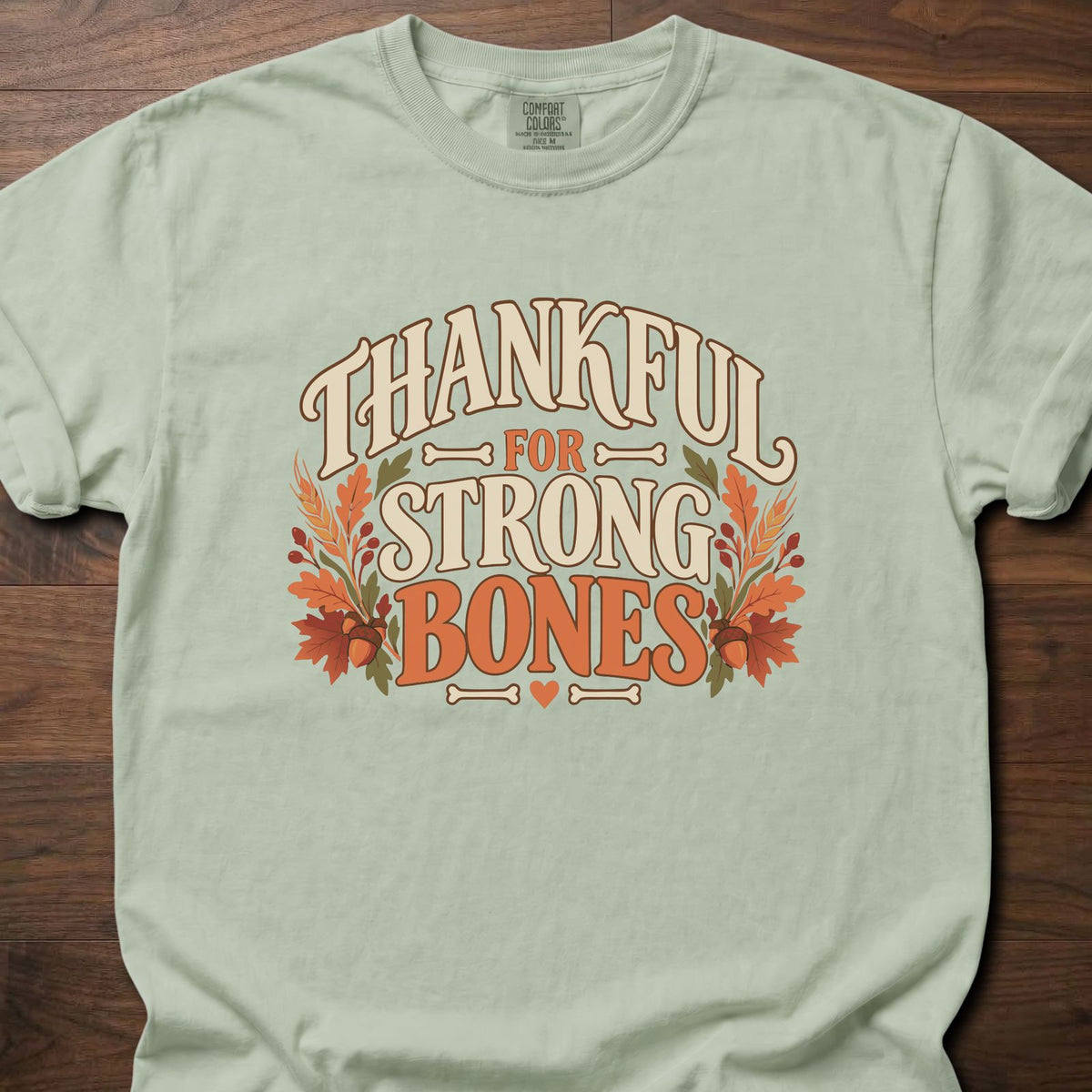 Thankful For Strong Bones strength training t-shirt with vintage collegiate typography and botanical – Bay