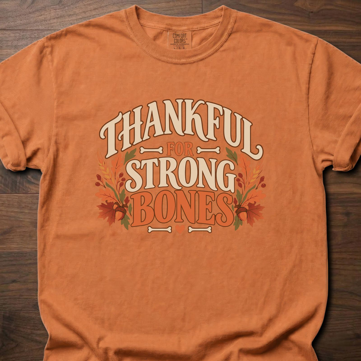 Thankful For Strong Bones strength training t-shirt with vintage collegiate typography and botanical – Yam