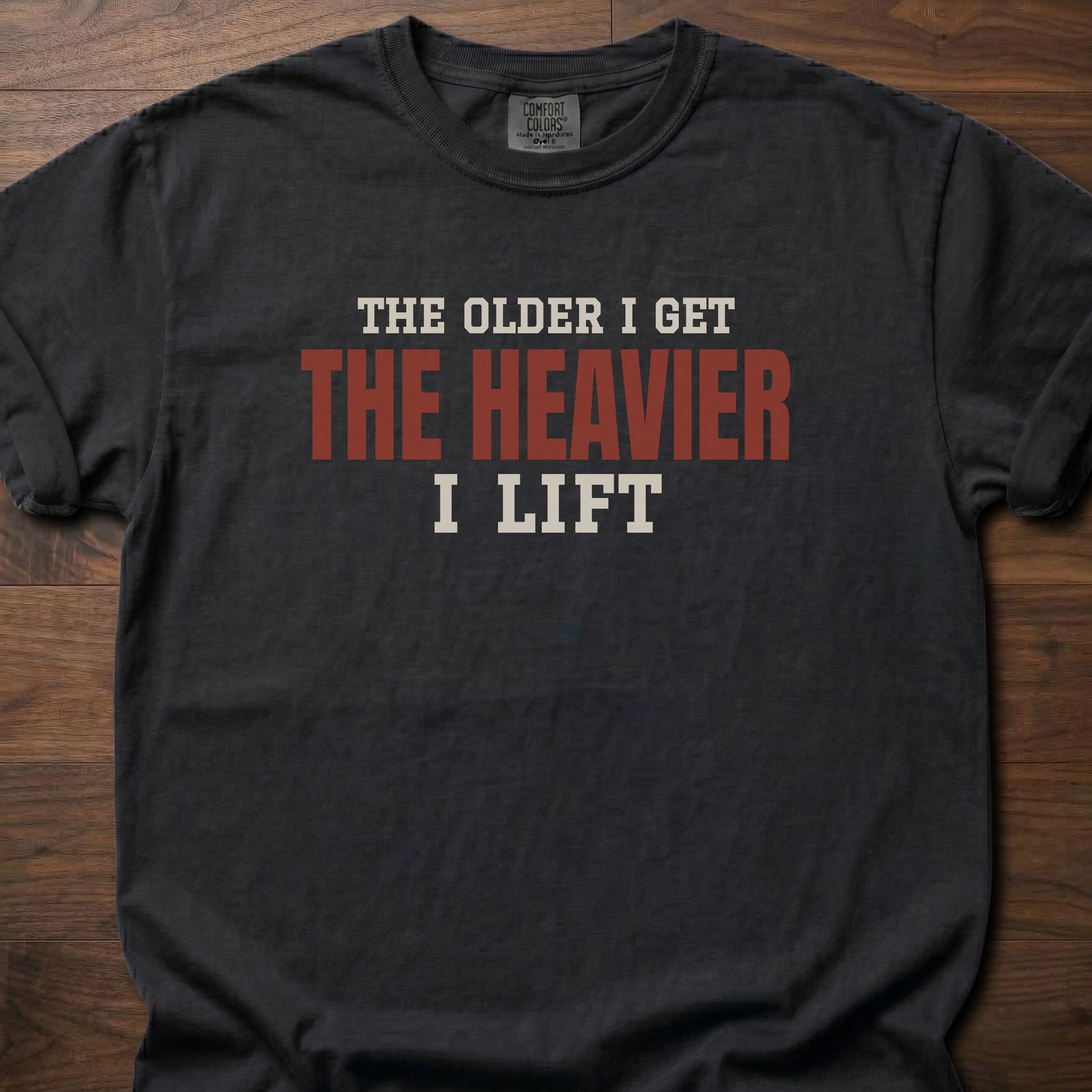 The Heavier I Lift fitness lifestyle t-shirt with bold stacked block-letter text design – Black