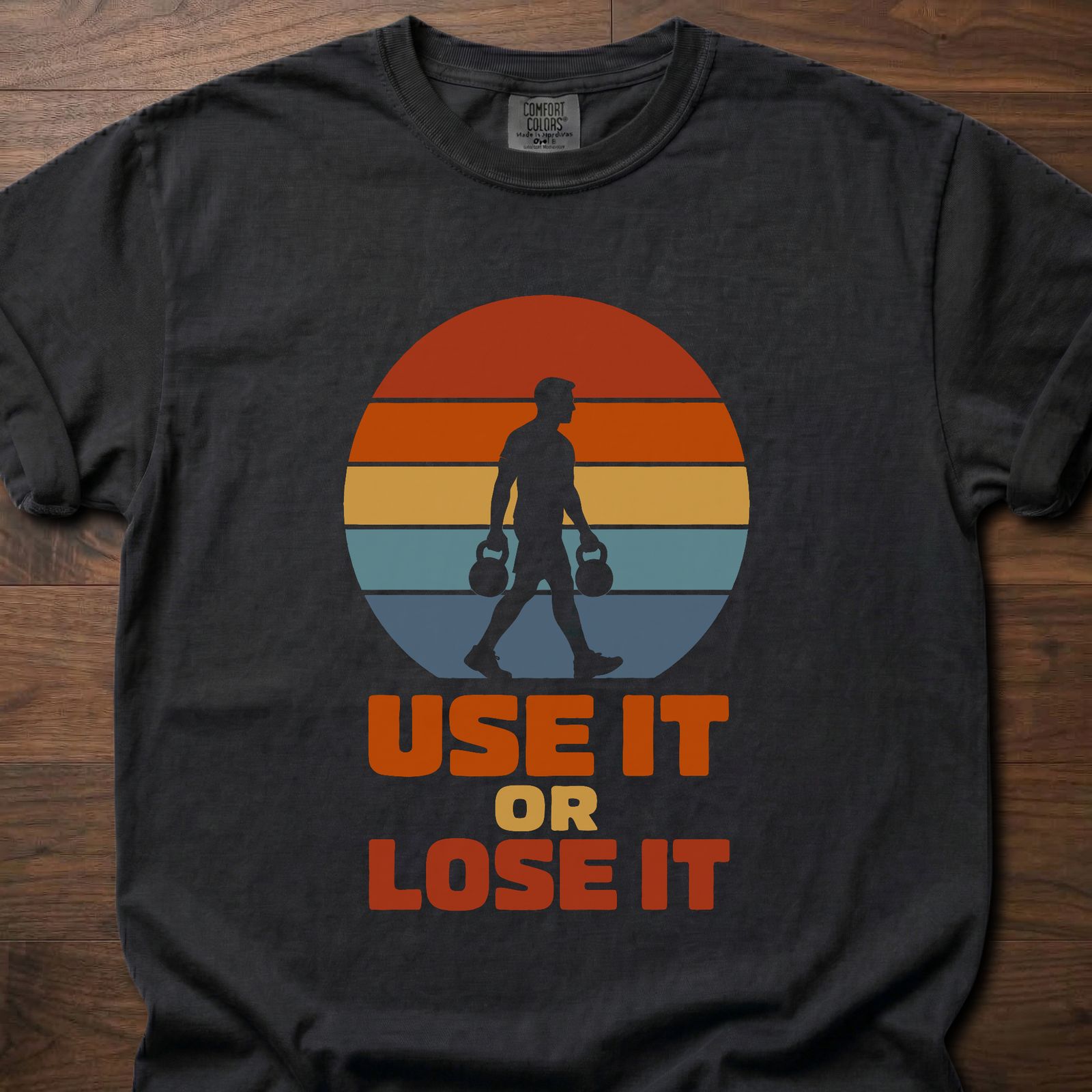 Use It Or Lose It strength training t-shirt with kettlebell walk and retro sunset graphic – Black