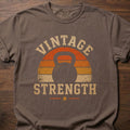 Vintage Strength fitness lifestyle t-shirt featuring retro sunset with kettlebell silhouette – Espresso