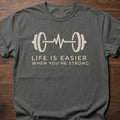 When You're Strong strength training t-shirt with barbell heartbeat design and motivational text – Pepper
